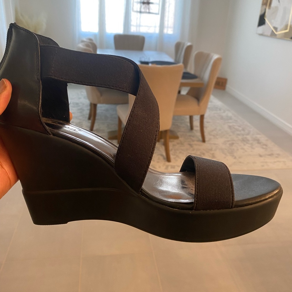 Strappy black heeled shoes.